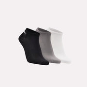 Three pairs of socks in black, gray, and white on a light gray background