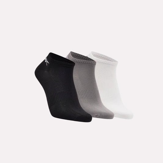 Three pairs of socks in black, gray, and white on a light gray background